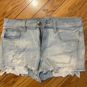 American Eagle light washed, cut off, hi-rise jean short. Lace on pocket.